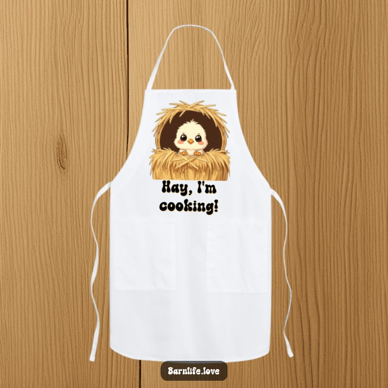 Funny Apron with a fluffy chick peeking from a straw bale, adding farm-fresh humor and practicality to any cooking session.