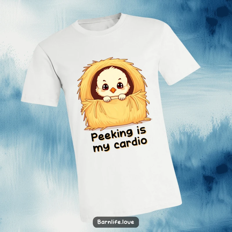 Funny chick t-shirt showcasing a fluffy baby bird with wide, curious eyes peeking from a hay bale, highlighting its adorable and playful nature.